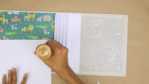 Using adequate glue to attach decorative elements to a baby scrapbook Stock Footage 280975339
