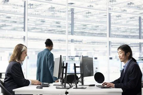Using AI machine learning, computer monitor and multiracial team Stock Photos
