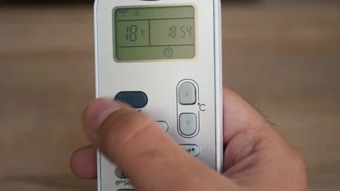 Using the air conditioner remote close up Stock Footage 106028673