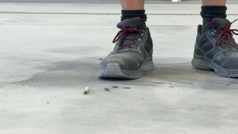 Using an angle grinder cutting rebar reinforcing bar on concrete floor base Stock Footage 348237855