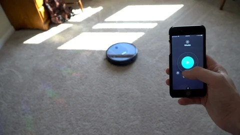 Using app to start robot vacuum device, clean apartment room Stock Footage 113973709