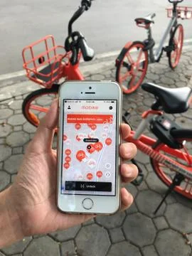 Using application on iPhone for “mobike” rental bicycle Stock Photos