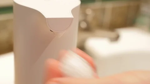 Using automatic foam soap dispenser, washing hands, close, macro Stock-Footage 125681330
