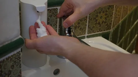 Using automatic foam soap dispenser, washing hands Stock Footage 125684064