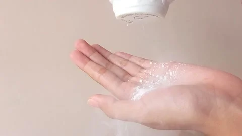 Using baby powder on a hand Stock Footage 146255260