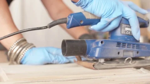 Using belt sander to restore old wooden furniture slow motion Stock Footage 78939595