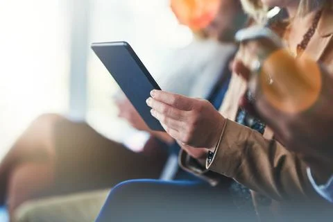 Using the best app to make notes. a woman using her digital tablet while sitting Stock Photos