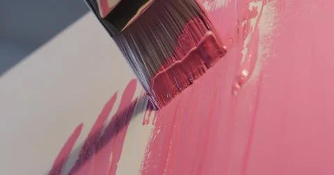 Using bigger brush to do initial painting strokes with pink color paint Photos