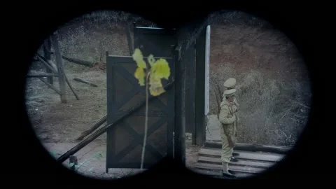 Using binoculars to observe the puppet troops on guard duty Stock Footage 276518458