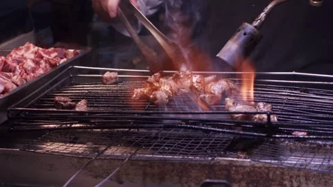 Using Blow Torch to cook meat, closeup, 4K Video stock 333050517
