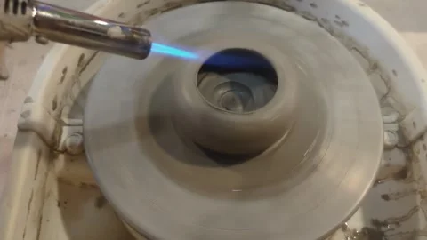 Using blow torch on pottery wheel Stock Footage 304753227