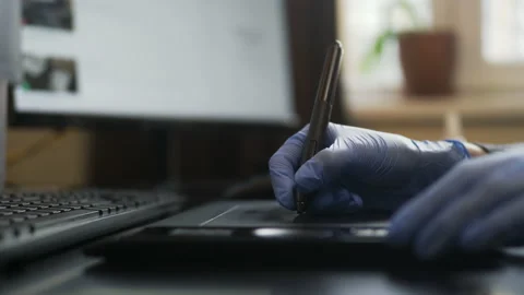 Using blue medical glowes for drawing by tablet, office work through Covid-19 Stock Footage 147374130