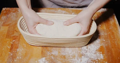 Using a bread proofing basket for sourdough loaf Stock Footage