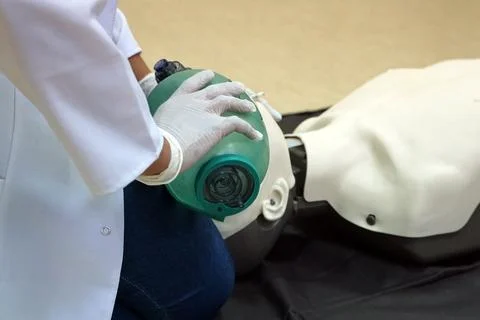 Using a Breathing bag (Ambu) by a student on a simulation dummy during BLS Stock Photos