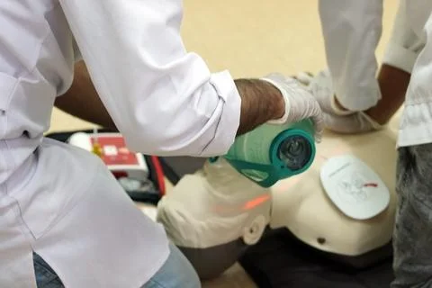 Using a Breathing bag (Ambu) by a student on a simulation dummy during BLS Stock Photos