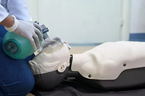 Using a Breathing bag (Ambu) by a student on a simulation dummy during BLS Stock Photos