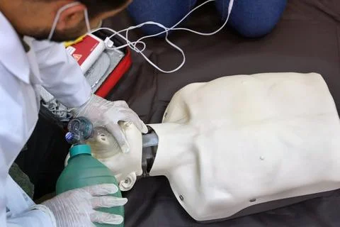 Using a Breathing bag (Ambu) by a student on a simulation dummy during BLS Stock Photos