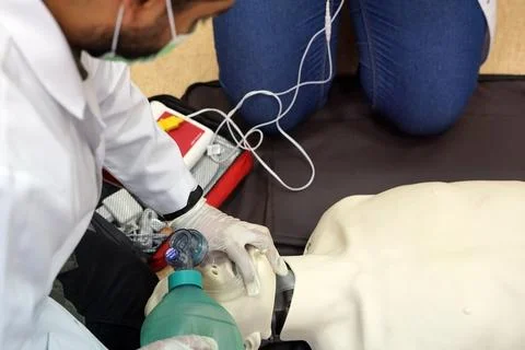 Using a Breathing bag (Ambu) by a student on a simulation dummy during BLS Stock Photos