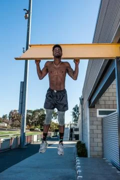 Using the building as exercise equipment. Stock Photos