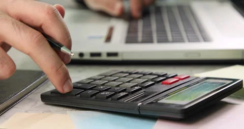 Using calculator and laptop same time 動画素材 139762118