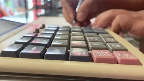 Using a calculator Calculate accounts and make notes. Stock Footage 252886887