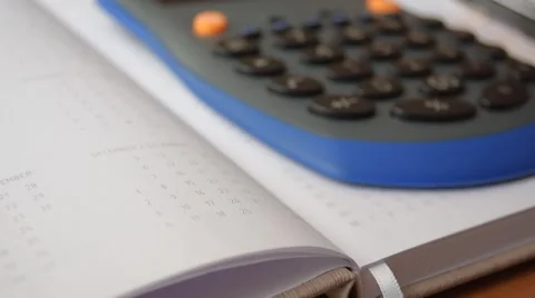 Using calculator on the diary Stock-Footage 60222449