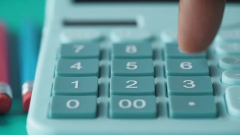 Using a calculator for math problems in a study space Stock Footage 312774531