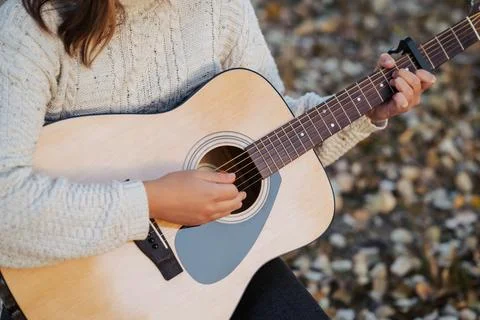 Using capo and mediator while learning to play the guitar Stock Photos