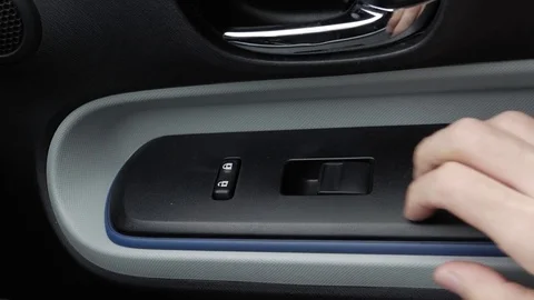 Using the Car Window Switch To Roll Down The Window Stock Footage 81151059