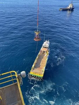 Using a cargo basket on a supply ship 스톡 사진