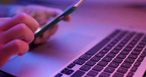 Using cellphone with laptop computer Stock Footage 89188221