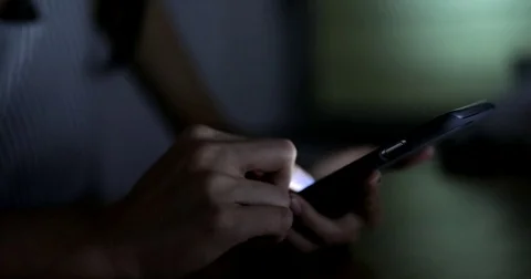 Using cellphone at night Stock Footage