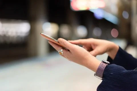 Using cellphone in the rail station Stock Photos