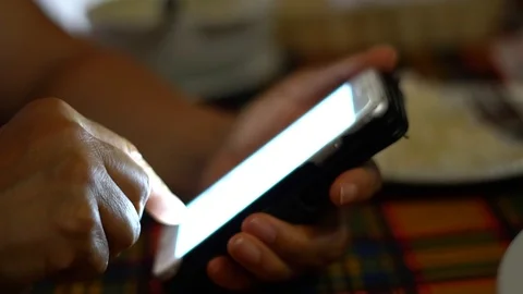 Using Cellphone at Restaurant Table Stock Footage 102485076