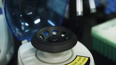 Using a centrifuge to mix viles of a virus with other substances Stock Footage 127533505
