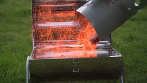 Using a chimney starter to light a portable camping barbecue Stock Footage 316383452