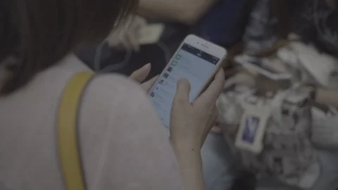 Using Chinese cellphone on subway train Stock Footage 113897757