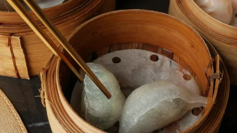 Using chopstick picking up tradition chinese food dim sum Dumplings which s.. Stock Footage 296089423