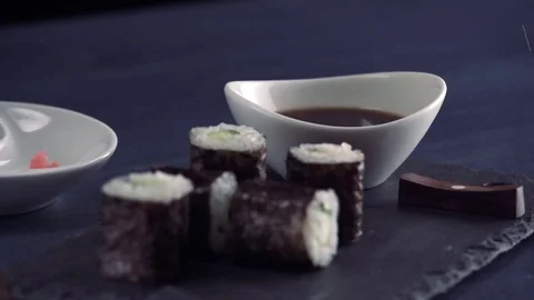 Using chopsticks to dip sushi into soy sauce, Japanese Food Video stock 84824788