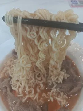 Using chopsticks to eat Stock Photos