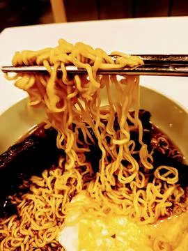 Using chopsticks to eat Stock Photos