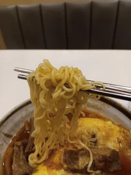 Using chopsticks to eat Stock Photos