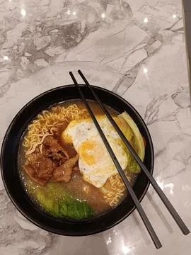 Using chopsticks to eat Stock Photos