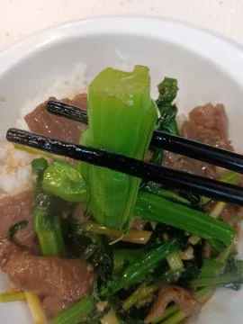Using chopsticks to eat vegetables Stock Photos