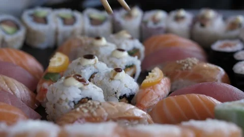 Using chopsticks to hold sushi 4k Stock Footage 138232796