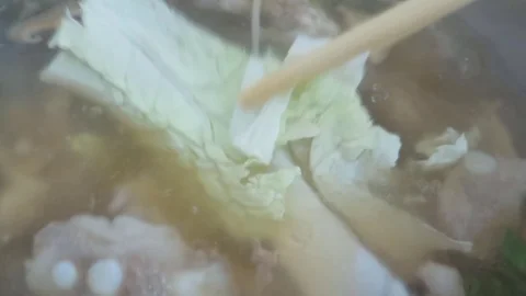 Using chopsticks seafood soup Stock Footage 70613717