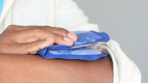 Using cold packs for pain relief on sore muscles Stock Footage 304308500