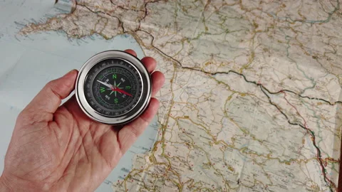 Using a compass with a geographic map Stock Footage 220570868