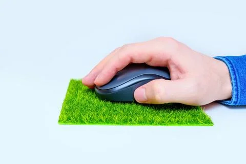 Using a Computer Mouse on a Grass Mousepad 写真素材
