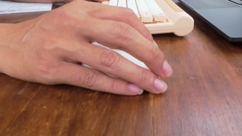Using Computer Mouse with Keyboard on Wooden Desk 動画素材 311793556